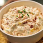 Delicious Million Dollar Dip served in a bowl, perfect for parties and gatherings.