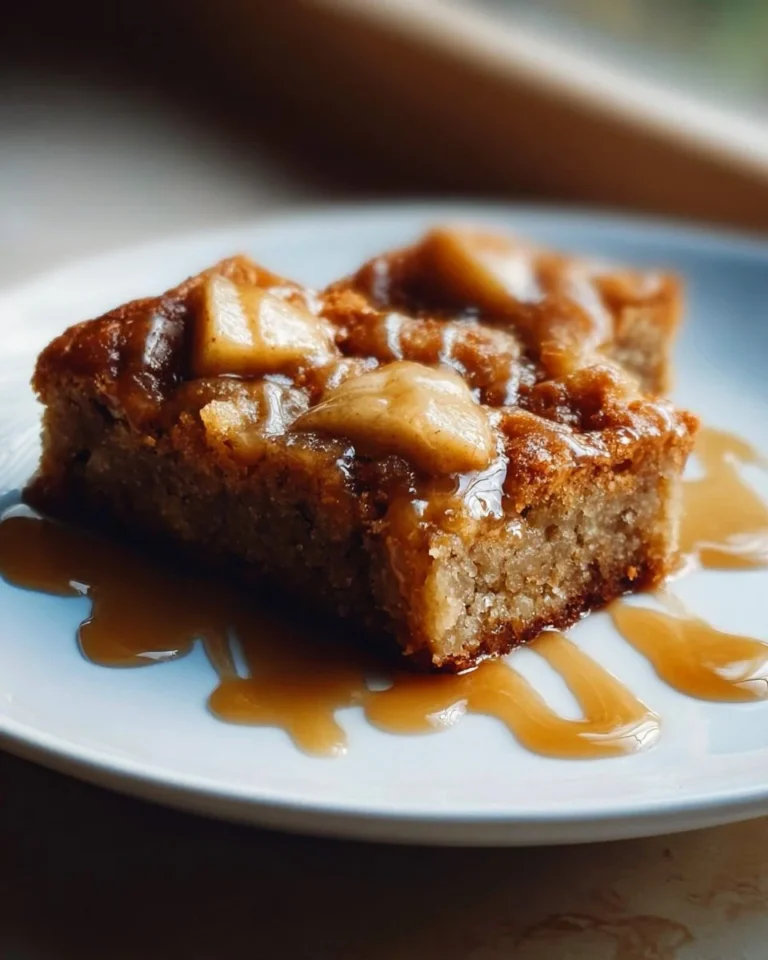 Delicious Maple Glazed Apple Blondies topped with a sweet glaze and fresh apple slices.
